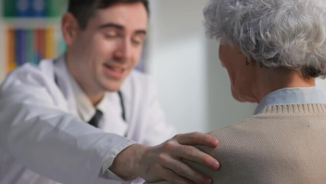 Close up of smiling doctor telling good news about recovery to aged patient