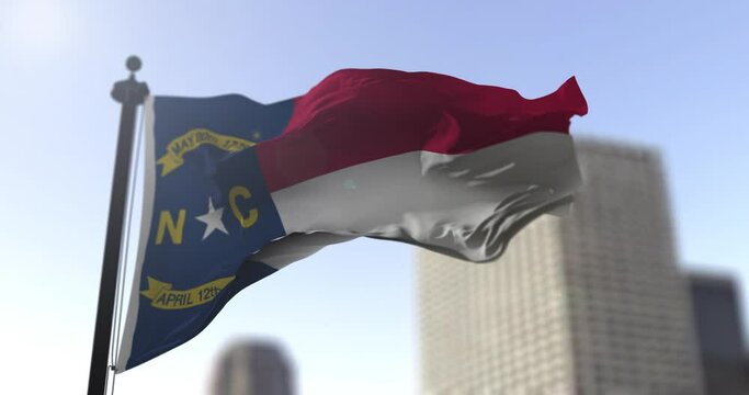 North Carolina state waving flag on blurry background, USA state news illustration. Blurry background