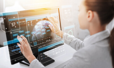 virtual reality, technology and cyberspace concept - businesswoman working with earth globe hologram and data on touchscreen of computer monitor at office