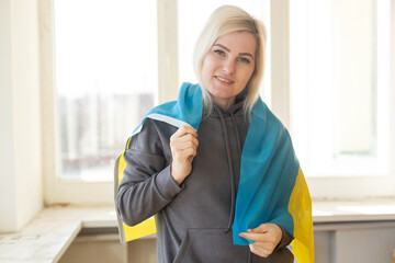 woman wrapped in Ukraine flag.