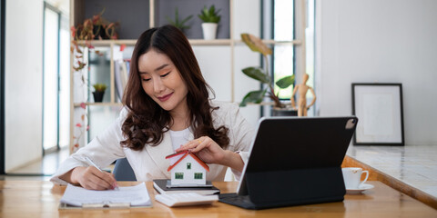 Fototapeta premium Close up of Business woman pointing and signing agreement for buying house. Bank manager concept.