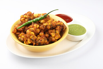 Crispy Corn pakora/pakoda, bhajji, Bhaji, bajji or pattice . served with tomato ketchup & mint chutney