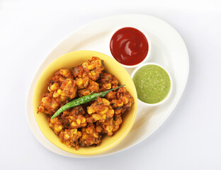 Crispy Corn pakora/pakoda, bhajji, Bhaji, bajji or pattice . served with tomato ketchup & mint chutney