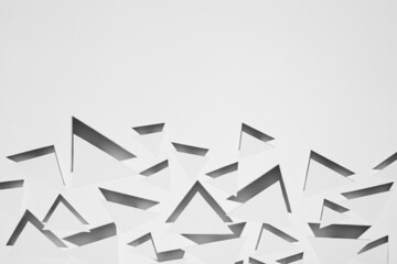 White simple geometric background with flying triangles in hard light with black sharp shadows as energy aggressive pattern, border, copy space, top view. Futuristic minimal backdrop.