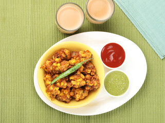 Crispy Corn pakora/pakoda, bhajji, Bhaji, bajji or pattice . served with tomato ketchup ,mint chutney & masala tea