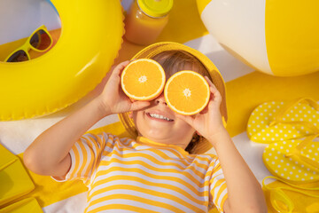 Happy child lying on beach towel