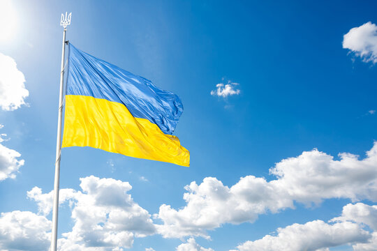 Ukraine flag isolated on the blue sky with clipping path. close up waving flag of Ukraine. flag symbols of Ukraine