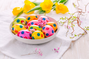 Easter eggs and tulips on grey background