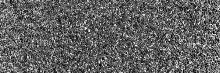 The pattern of small black pebbles stone. Panoramic background