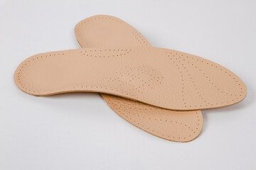 Insoles isolated on a white background. Medical orthopedic insoles. Foot care. Insole cutaway layers. Treatment and prevention of flat feet and foot diseases. Inner soles of shoes