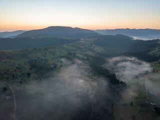Fototapeta premium Morning fog in the Ukrainian Carpathians. Aerial drone view.