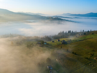 Green mountains of the Ukrainian Carpathians in the morning mist. Aerial drone view.