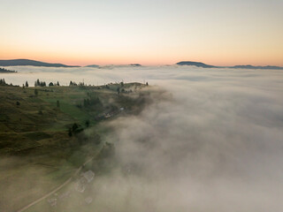Sunrise over the fog in the Ukrainian Carpathians. Aerial drone view.