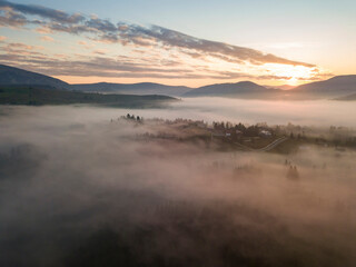 Obraz premium Sunrise over the fog in the Ukrainian Carpathians. Aerial drone view.