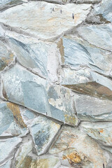 Grunge stone masonry wall texture. Decorative, uneven stone wall surface. Vintage background. 