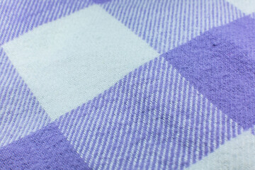 Checkered cloth texture. Purple and white squares on textile. Natural fabrics background.