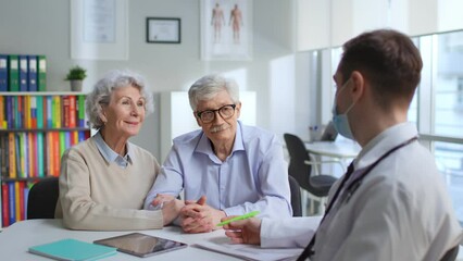 Happy senior couple having appointment with doctor in medical center - Powered by Adobe
