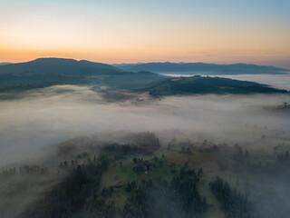 Obraz premium Morning fog in the Ukrainian Carpathians. Aerial drone view.