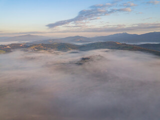 Sunrise over the fog in the Ukrainian Carpathians. Aerial drone view.