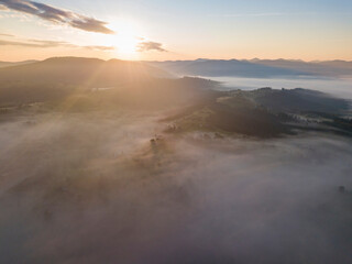 Sunrise over the fog in the Ukrainian Carpathians. Aerial drone view.