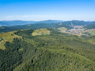 Naklejka na ściany i meble Green mountains of Ukrainian Carpathians in summer. Sunny clear day. Aerial drone view.