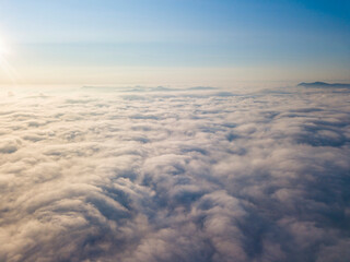 High flight above the clouds. Aerial drone view.