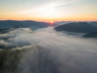 Sunrise over the fog in the Ukrainian Carpathians. Aerial drone view.