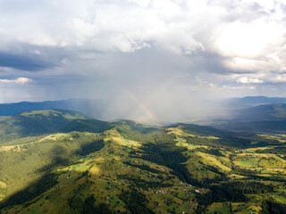 Obraz premium Rainbow in the mountains of the Ukrainian Carpathians. Aerial drone view.