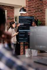 Multiethnic developer team talking about rising number of system security breaches. Tech engineers...