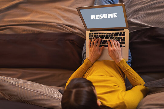 Back view of woman writing on laptop screen the word CV online, working from home, female applicant typing cover letter, applying for job,