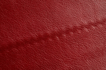 Fototapeta premium Red leather texture background. Luxury genuine textile surface material wallpaper with furniture backdrop. Close up of fashion fabric