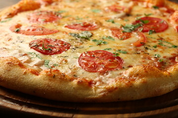 Pizza with tomatos, cheese and ham on a dark background. Italian pizza
