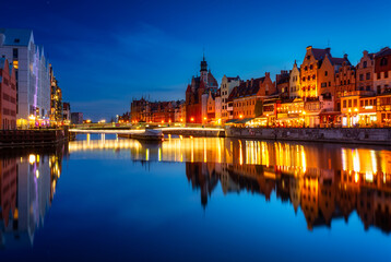Naklejka na ściany i meble Beautiful architecture of Gdansk old town reflected in the Motlawa river at dusk, Poland