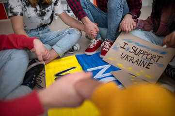 Close-up of students praying for Ukraine at school.