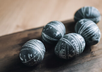 Easter eggs painted with karkade tea on a wooden board