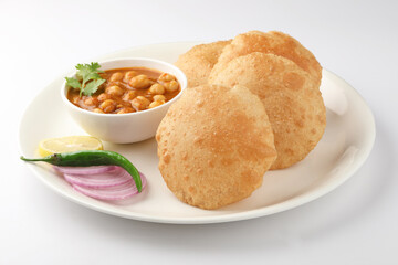 Puri and Chole traditional Indian food 
Indian dish spicy Chick Peas curry also known as Chola/Chana Masala or commonly Chole, served served with fried puri or poori  