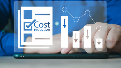 Cost reduction Concept. Businessman with his hand lowers the arrow of the graph. Cost text with a...