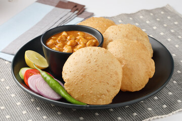 Puri and Chole traditional Indian food 
Indian dish spicy Chick Peas curry also known as Chola/Chana Masala or commonly Chole, served served with fried puri or poori  
