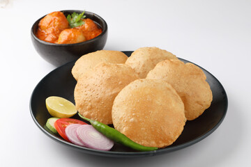 Puri and Chole traditional Indian food 
Indian dish spicy Chick Peas curry also known as Chola/Chana Masala or commonly Chole, served served with fried puri or poori  