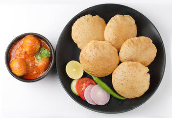 Puri and Chole traditional Indian food 
Indian dish spicy Chick Peas curry also known as Chola/Chana Masala or commonly Chole, served served with fried puri or poori  