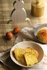 Plate of traditional sweet bread, eaten at Easter time in Croatia. Easter bunny, eggs and flowers on the table. Selective focus.