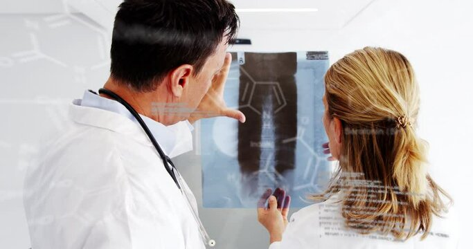 Animation of formulas and data processing over caucasian female and male doctors with xray photo
