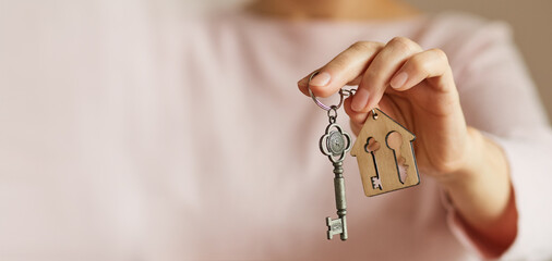 woman's hand holds the key to the apartment. Image with copy space, space for text for advertising