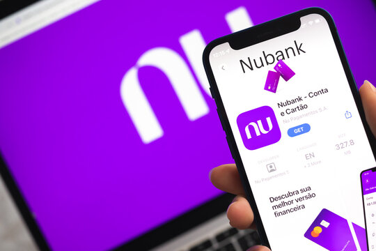 Nubank app icon. Hand with mobile phone with application. Mobile banking concept photo