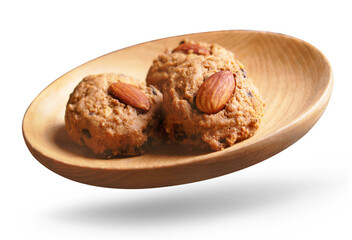 Almond cookies in a wooden bowl isolated on white background.