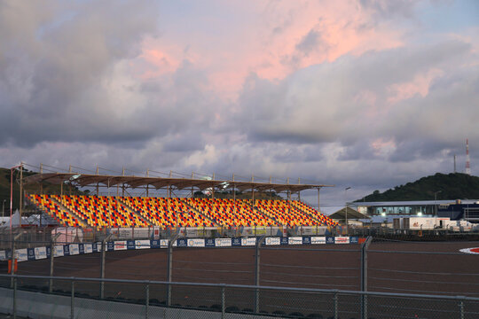LOMBOK, INDONESIA-MARCH 17, 2021 : VIP tribune in colorful audience seats of Mandalika Circuit for MotoGP and F1 with sunset violet sky 