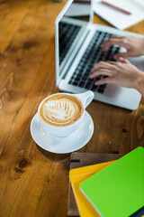 women using laptop with  coffee cup