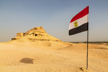 Mountain of the Dead in Siwa and a flag of Egypt, Siwa Oasis, Egypt