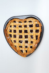 a intertwined cherry homemade pie sprinkled with powdered sugar