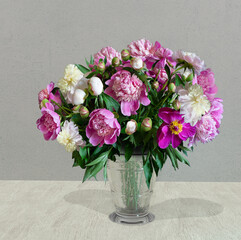 beautiful still life with fresh peonies in a glass vase on a wooden table
